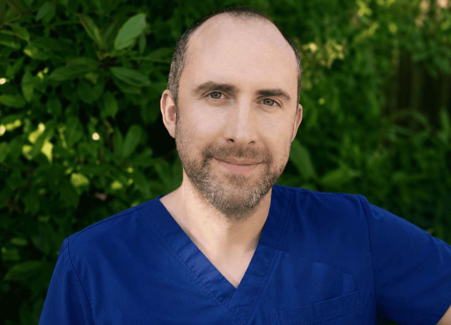 Skilled medical aesthetic professional in blue scrubs outdoors.